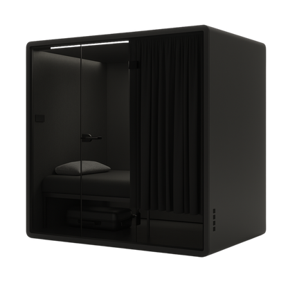 Soundproof First Class black NapBox Sleeping Pod - front angled view with bed, luggage storage, control panel, and privacy curtain.