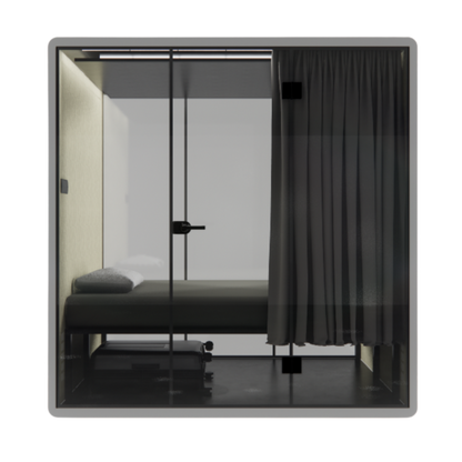 Soundproof First Class NapBox white Sleeping Pod - front view with bed, luggage storage, control panel, and privacy curtain.
